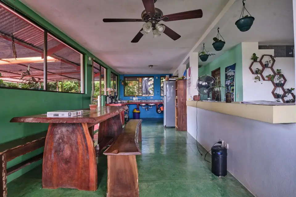The communal kitchen and dining area with a long wooden table