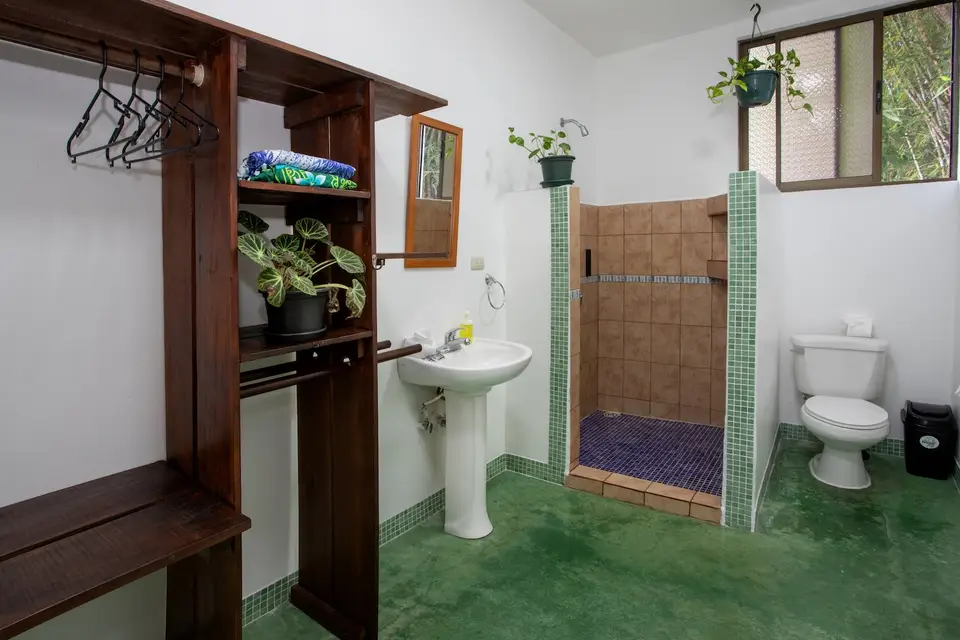 Villa Fresca’s large private bathroom with a wooden vanity