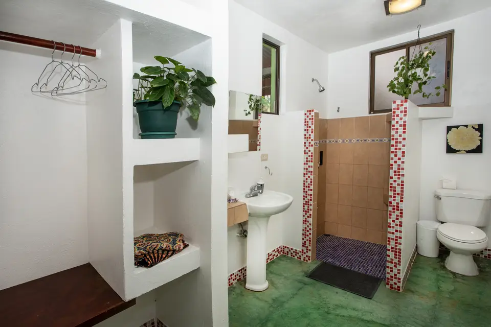 Villa Fresca’s private bathroom with shelves, basin and shower