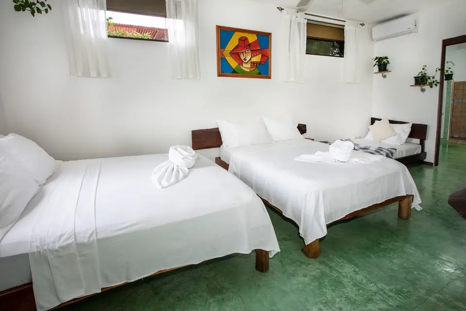 Villa Fresca: two double beds and a single bed with a patterned throw