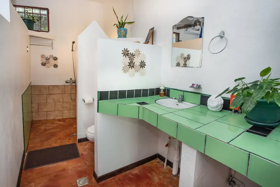 Villa Luna’s private bathroom with a green-tiled counter