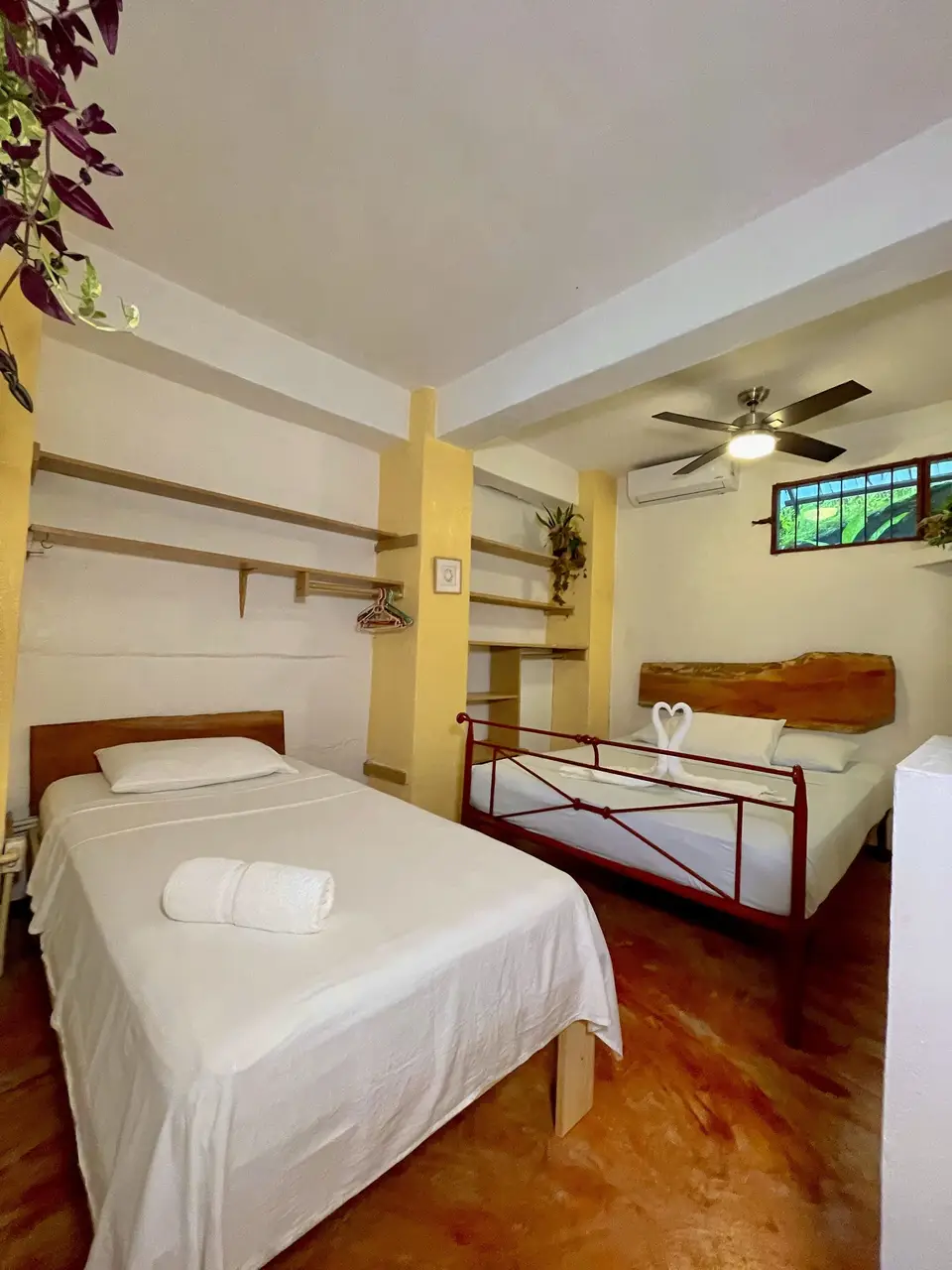 Villa Luna: the bedroom, with a large bed and a single bed on a red iron frame