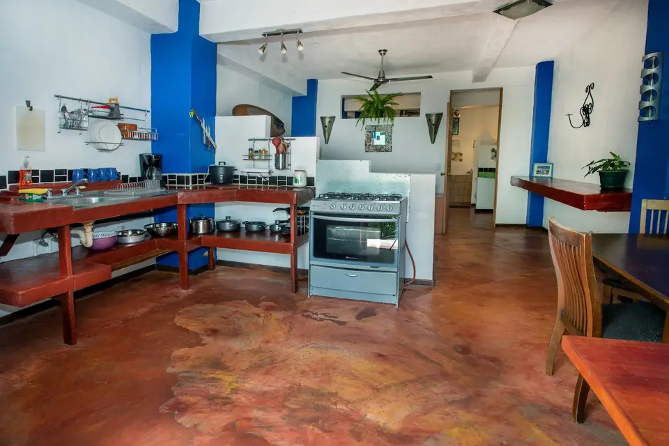 Villa Luna’s private kitchen with stove, fridge and wooden shelves