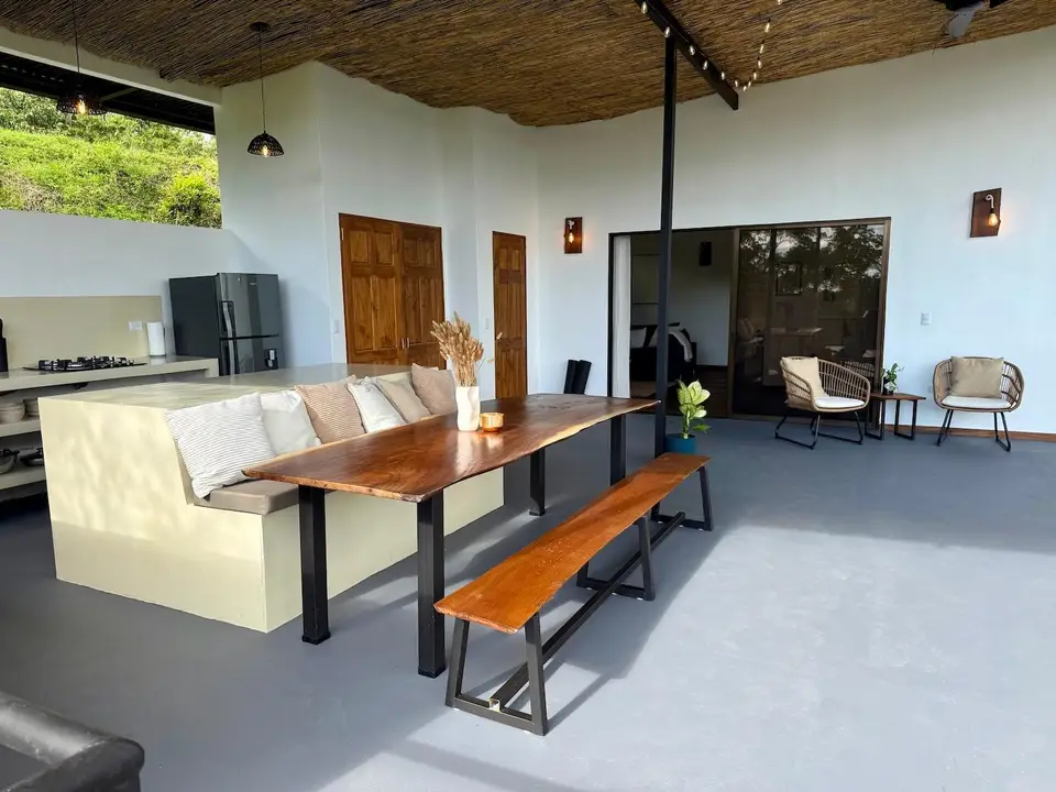 Bird’s Nest Apartment: wooden dining table and bench beside the kitchen