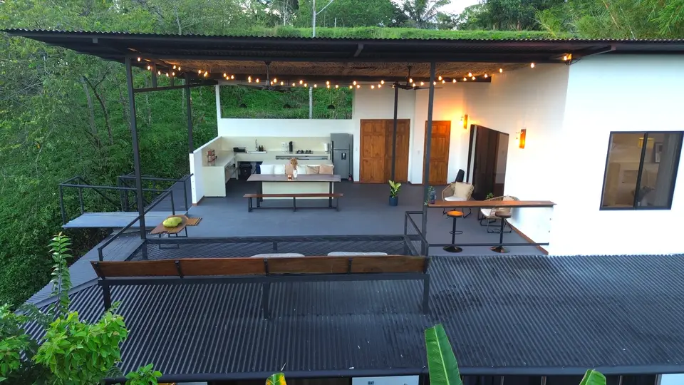 The Bird’s Nest terrace from above: string lights, a long table and the outdoor kitchen