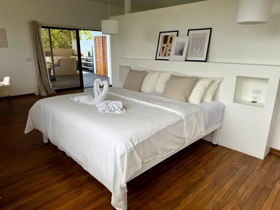 Bird’s Nest Apartment: the king bed with towels folded into a swan