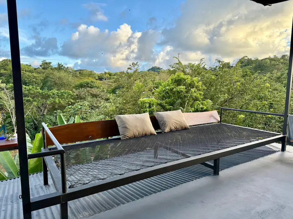 Bird’s Nest Apartment: a cushioned day bed on the open terrace above the jungle valley
