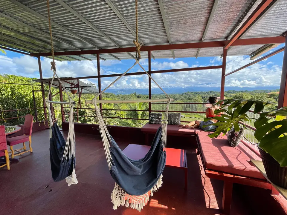 El Palomar: two hanging hammock chairs on the open-air rooftop, the valley wide open below
