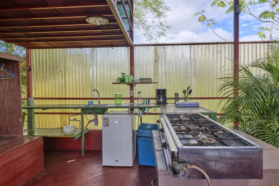 El Palomar’s open-air kitchenette: gas range, sink counter and a small fridge