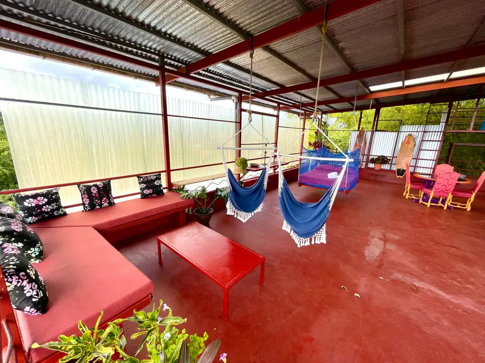 El Palomar: red couch, hammocks and a coffee table in the open air