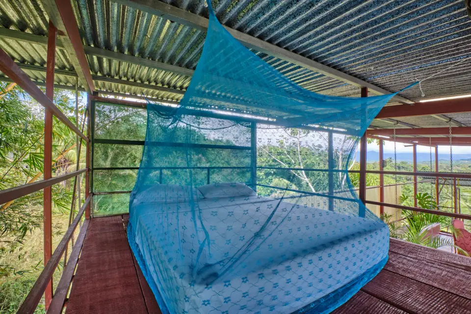 El Palomar: a bed under a turquoise mosquito net