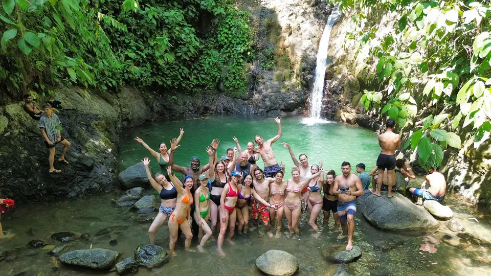 A retreat group at the foot of a waterfall pool on an excursion