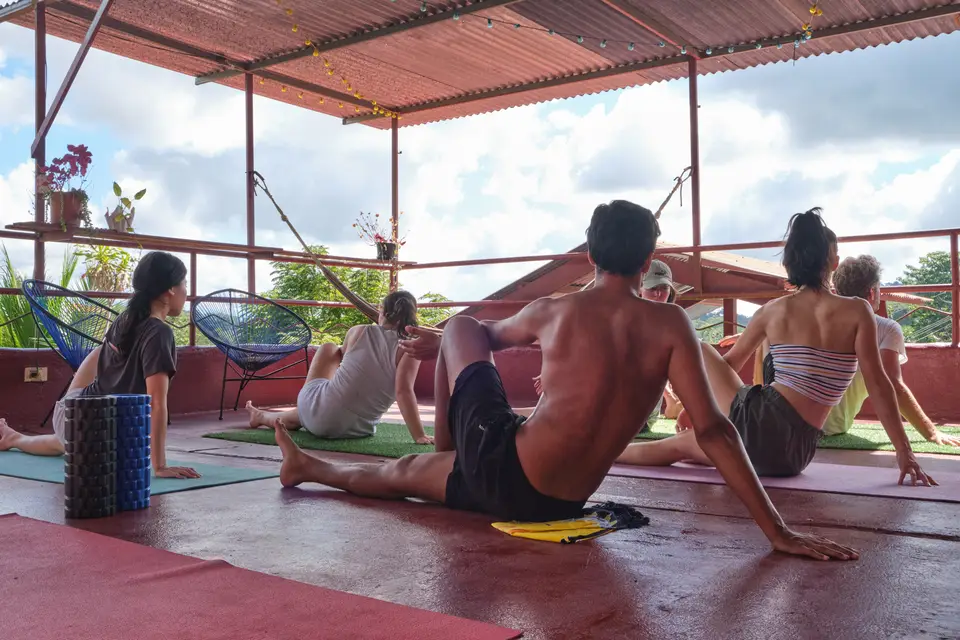 Guests in a morning stretch session on the rooftop terrace