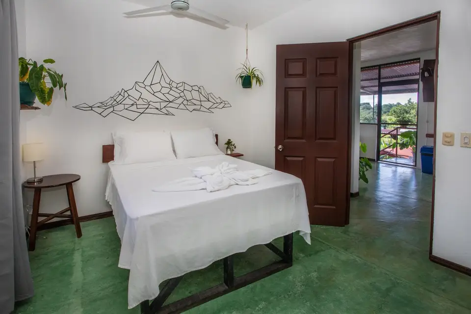 Villa Vista: a double bed under a sculptural wall light