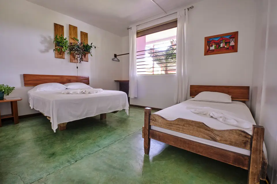 Villa Vista, bedroom one: a double bed and a single bed on wooden frames