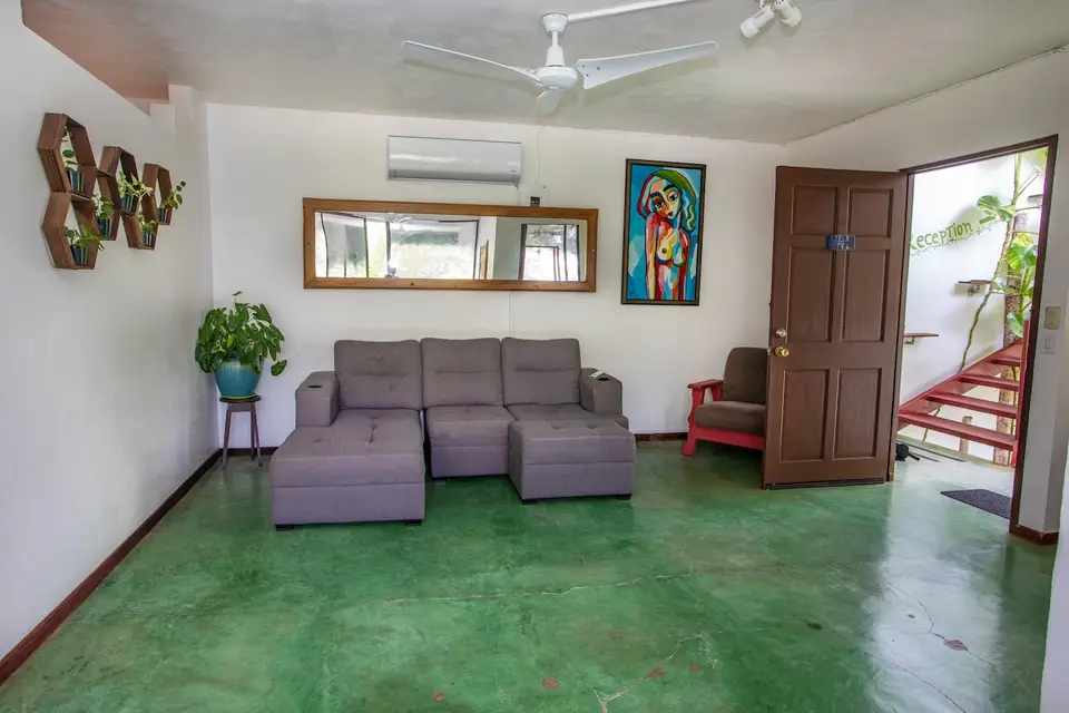 Villa Vista’s lounge: grey sectional sofa and colourful art
