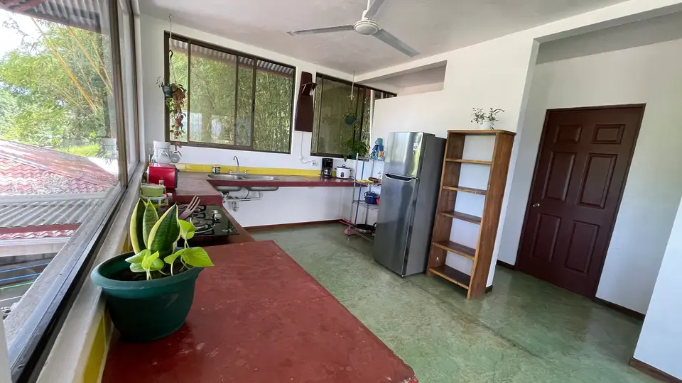 Villa Vista’s private kitchen: fridge, counter and a bookshelf